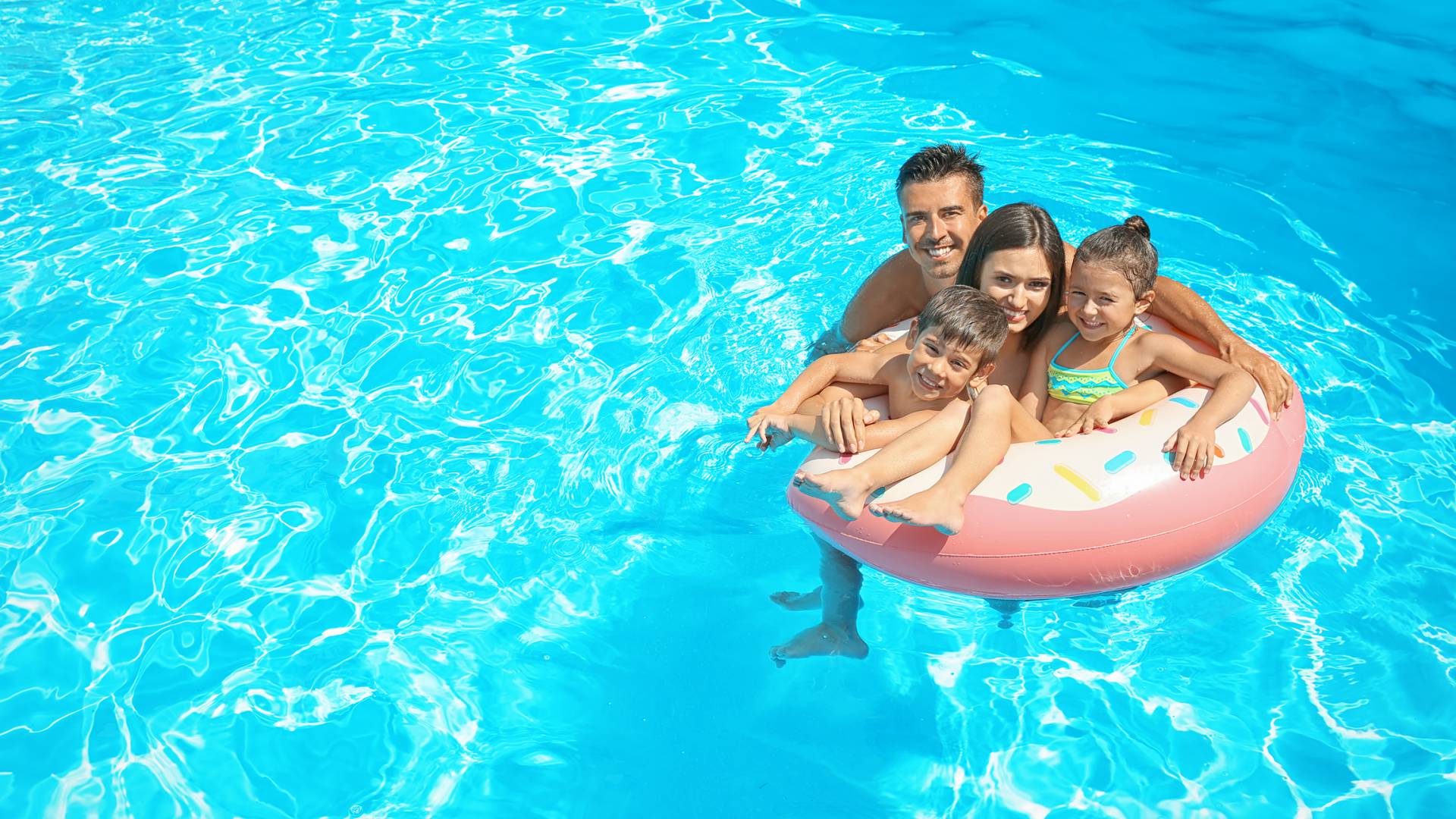 family in the open air swimming pool