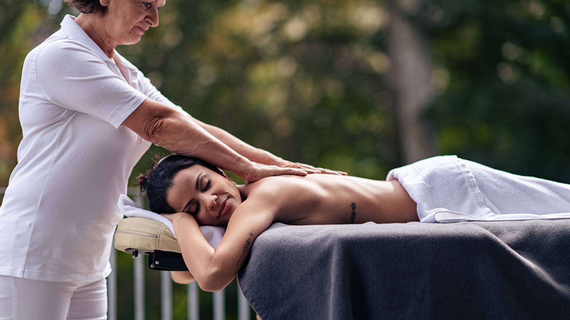 Woman with masseuse in the wellness area